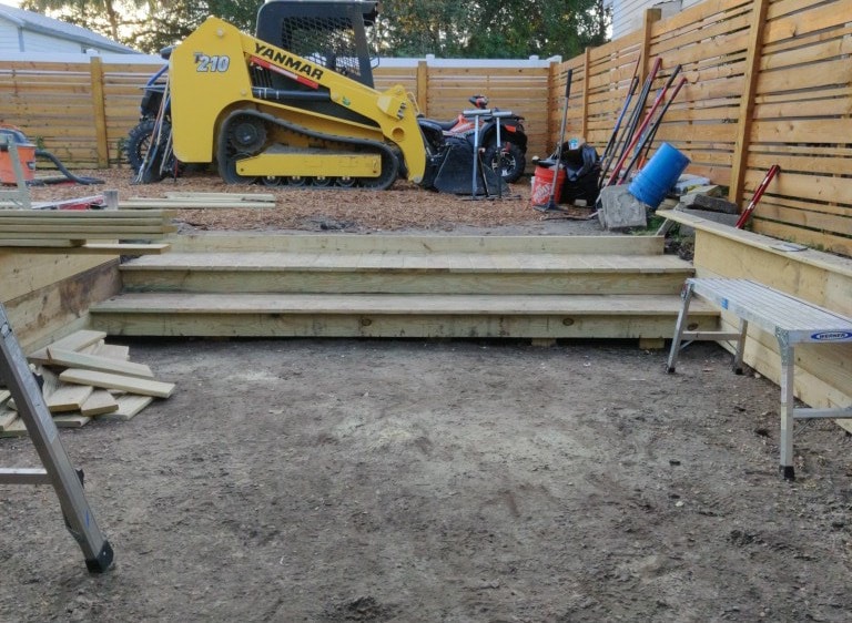 Early-stage foundation and framing work on a new lakefront construction project by Red Star.