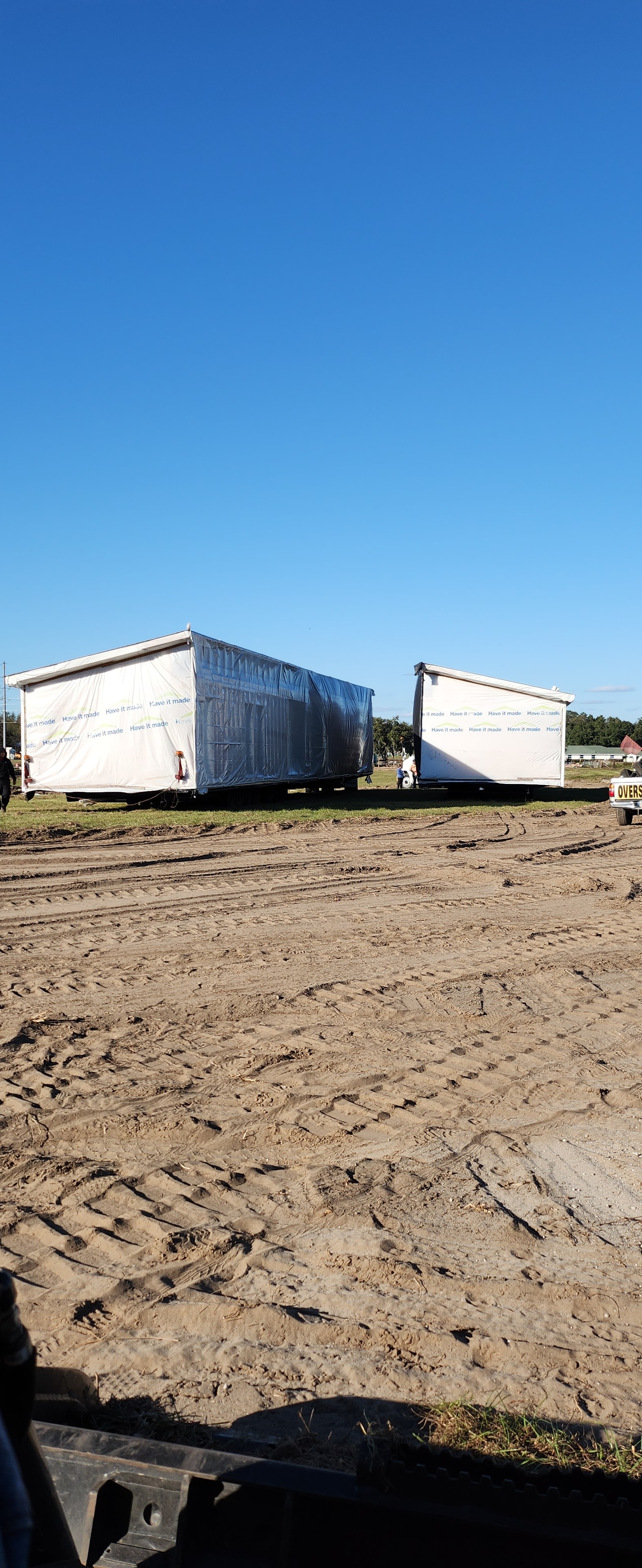 Active Red Star land development site with Red Star-branded trailers staged on a cleared parcel.
