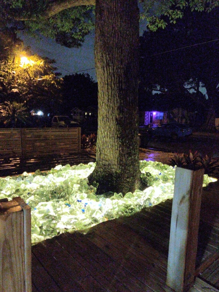 Completed horizontal fence with integrated landscape lighting and palm trees at a Red Star project site.