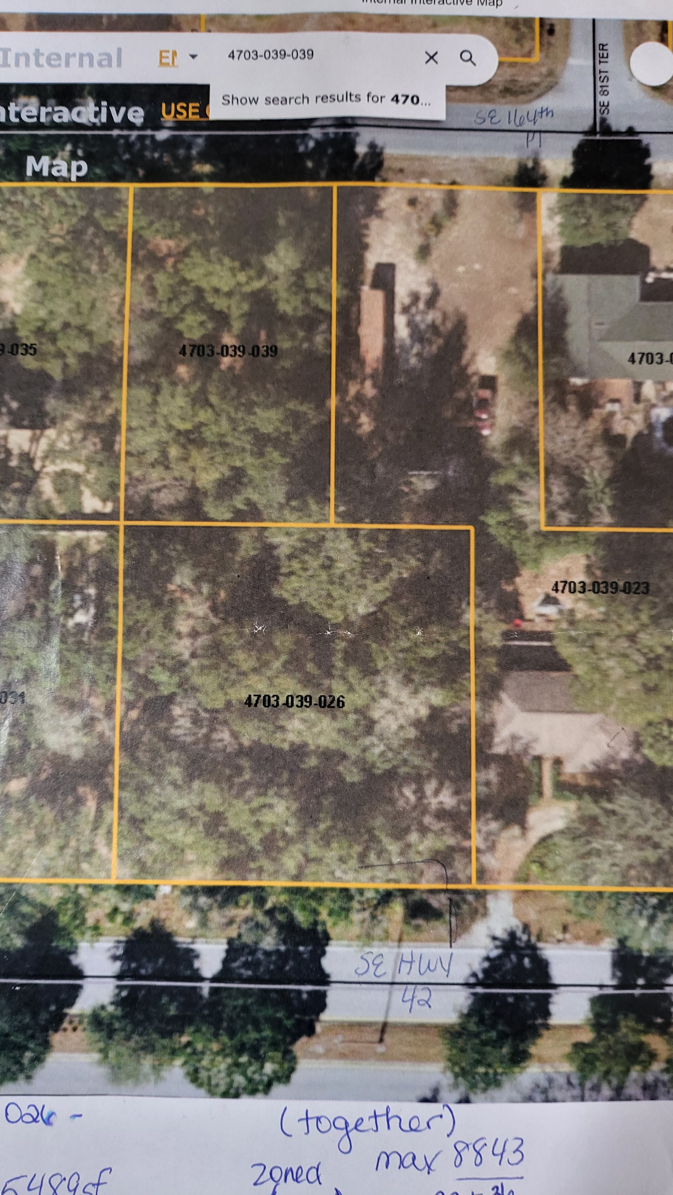 Aerial parcel map showing land parcels along SE Hwy 42, annotated with parcel IDs and zoning notes.