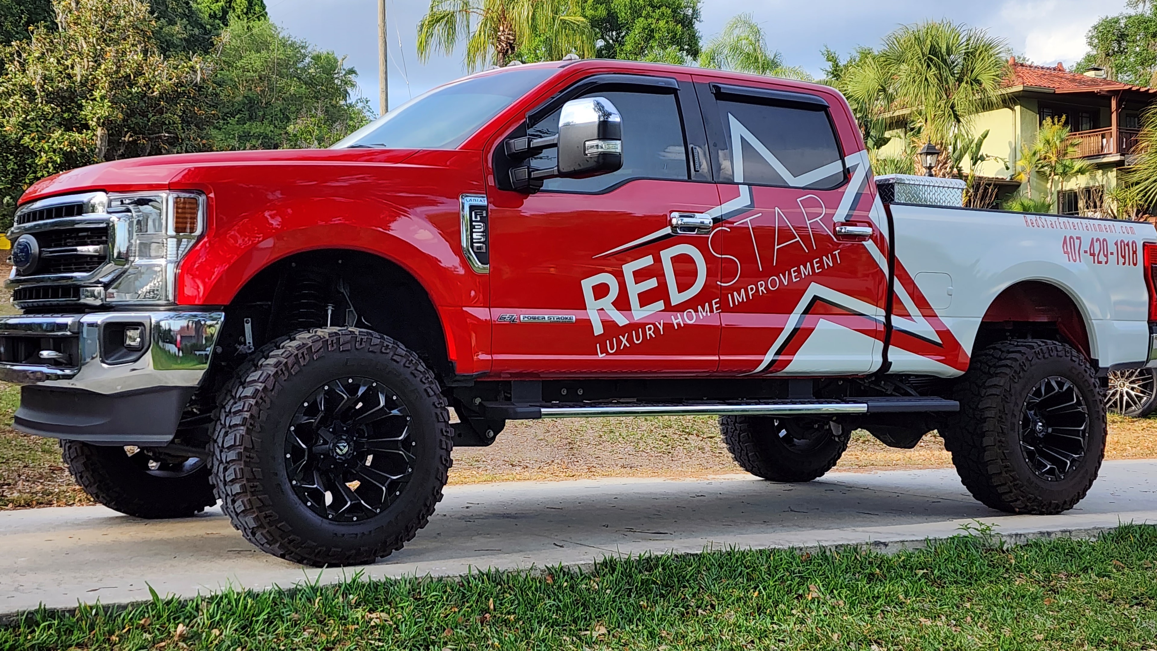 The iconic Red Star Luxury Home Improvement F-250 Super Duty with full custom wrap, lifted on off-road wheels.