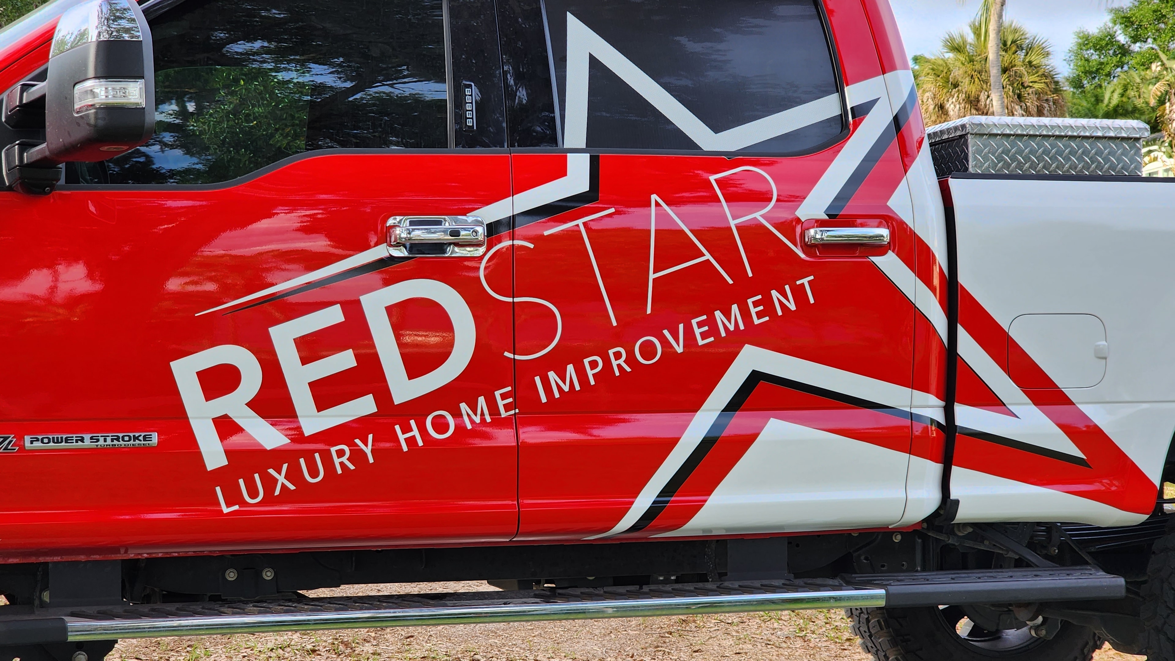 Close-up of the Red Star Luxury Home Improvement truck door wrap with bold star graphic and branding.